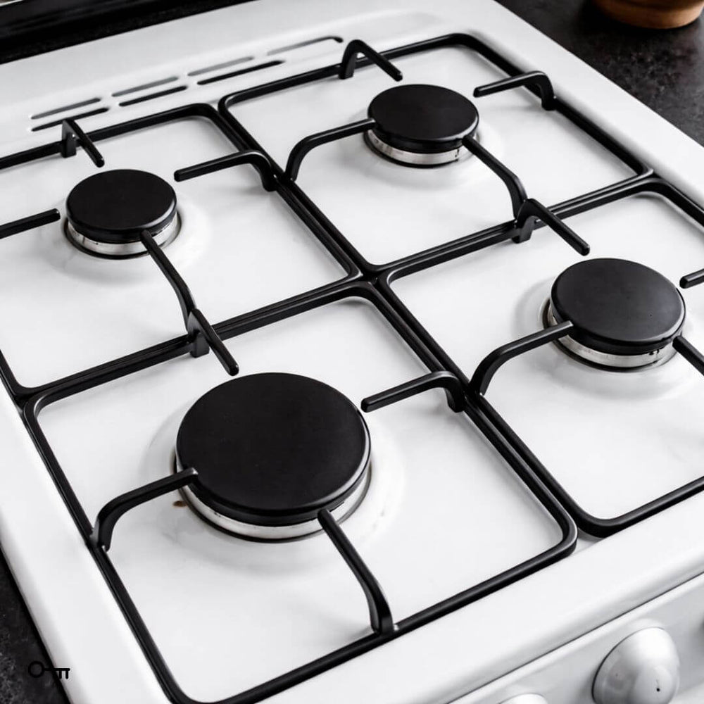 Gas stove with four burners on a white background