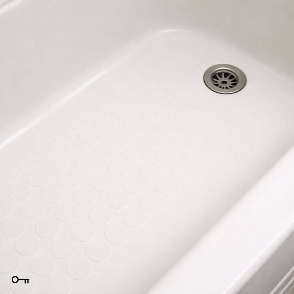 Close-up of a white kitchen sink with a drain